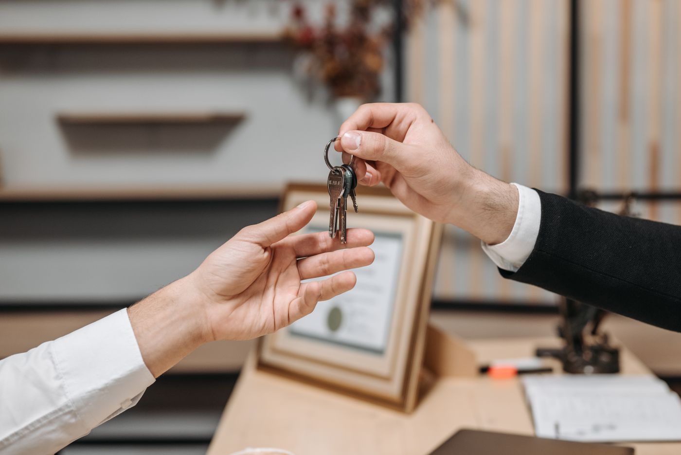A house-key handoff illustrating move-in day